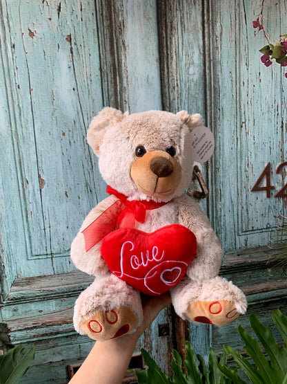 Beige bear holding love heart